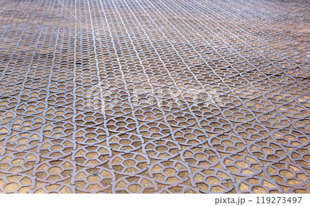 ancient 19th century pavement made of round cast iron blocks 119273497