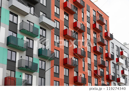 Modern high-rise apartment buildings in a vibrant residential area showcasing colorful balconies and Modern high-rise apartment buildings in a vibrant residential area showcasing colorful balconies and 119274340
