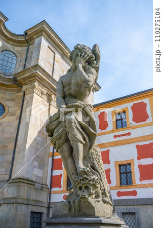 A striking Baroque statue stands thoughtfully at the Kuks hospital complex in Czechia, highlighting the intricate artistry and historical significance of the site. 119275104