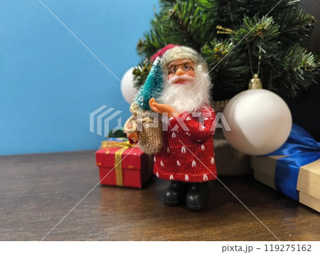 New Year Santa Claus near the Christmas tree. New Year Santa Claus near the Christmas tree. 119275162