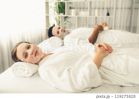 Woman customer indulges in rejuvenating with facial skincare mask. Quiescent Woman customer indulges in rejuvenating with facial skincare mask. Quiescent 119275820
