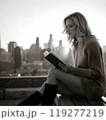 ビルの屋上で読書をする美しいアメリカ人女性(モノクロ) 119277219
