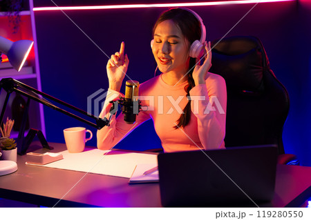Smiling creative young beautiful Asian influencer talking in channel. Stratagem. Smiling creative young beautiful Asian influencer talking in channel. Stratagem. 119280550