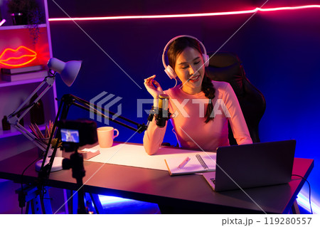 Smiling creative young beautiful Asian influencer talking in channel. Stratagem. Smiling creative young beautiful Asian influencer talking in channel. Stratagem. 119280557