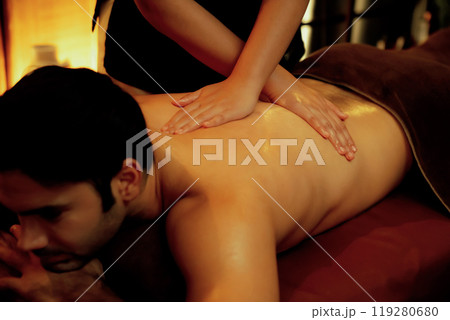 Caucasian man customer enjoying relaxing anti-stress massage. Quiescent Caucasian man customer enjoying relaxing anti-stress massage. Quiescent 119280680