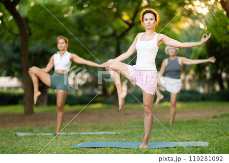 Adult woman doing yoga in park Adult woman doing yoga in park 119281092