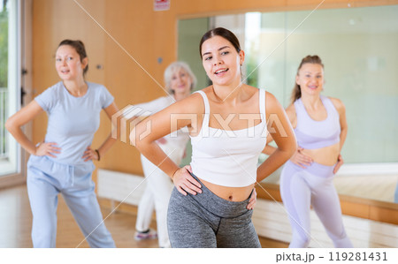 Active young woman practicing aerobic dance in training hall Active young woman practicing aerobic dance in training hall 119281431