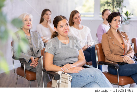 In audience, students sit staring at teacher and listen to lecture In audience, students sit staring at teacher and listen to lecture 119281465
