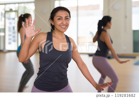 Portrait of young smiling hispanic woman dancing 119281682