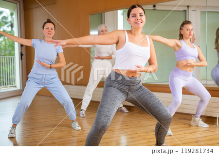 Group are practising arch movement in step jazz dance in fitness gym 119281734
