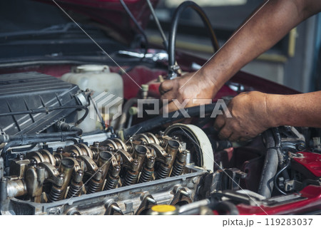 Close up Man hands fixing Car machinery vehicle mechanical service. Mechanic man hands repairing car auto repair shop. open vehicle hood checking up auto mobile. Vehicle Car maintenance engineer. 119283037