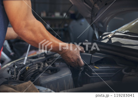 Close up Car Mechanic man hands repairing car auto repair shop. Man hands fixing machinery vehicle mechanical service. open vehicle hood checking up auto mobile. Vehicle Car maintenance engineer. Close up Car Mechanic man hands repairing car auto repair shop. Man hands fixing machinery vehicle mechanical service. open vehicle hood checking up auto mobile. Vehicle Car maintenance engineer. 119283041