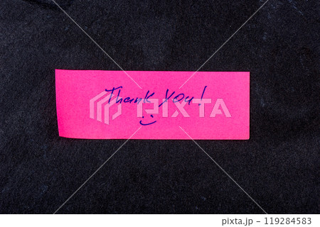 Colorful note expressing gratitude on a dark stone background. 119284583