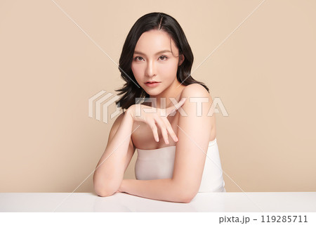 Beautiful young asian woman with clean fresh skin on beige background, Face care, Facial treatment, Cosmetology, beauty and spa, Asian women portrait. Beautiful young asian woman with clean fresh skin on beige background, Face care, Facial treatment, Cosmetology, beauty and spa, Asian women portrait. 119285711