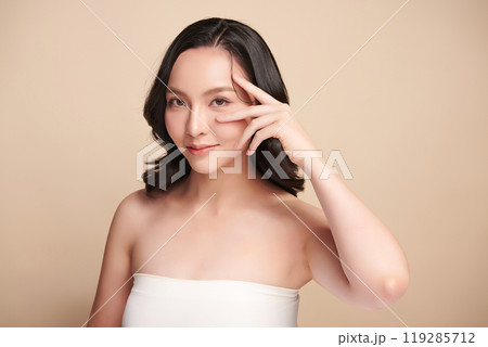 Beautiful young asian woman with clean fresh skin on beige background, Face care, Facial treatment, Cosmetology, beauty and spa, Asian women portrait. 119285712