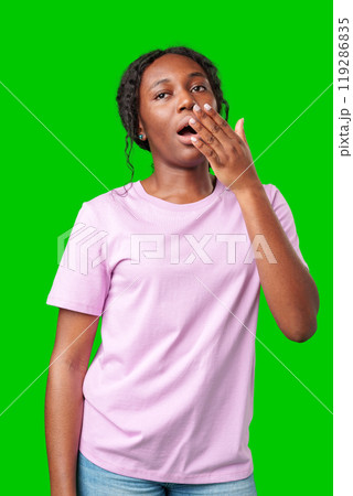 Woman expressing surprise and excitement on a bright green background 119286835