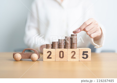 Happy New Year 2025 with car model and Coins Money stack for deposit and Automobile Tax. Money Saving, Car Insurance, Financial, vehicle Repair and Maintenance and New Year concept 119287485