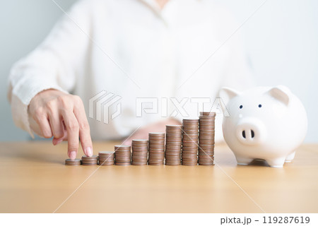 Money Saving for Future Plan, Retirement fund, Pension, Investment, Wealth, Salary and Financial concepts. hand step up coin with piggy bank on table, Money Counting and stack arrangement for Growth Money Saving for Future Plan, Retirement fund, Pension, Investment, Wealth, Salary and Financial concepts. hand step up coin with piggy bank on table, Money Counting and stack arrangement for Growth 119287619
