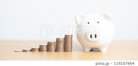 Money Saving for Future Plan, Retirement fund, Pension, Investment, Wealth Business and Financial concepts. hand putting coin into piggy bank on table, Money Counting and stack arrangement for deposit 119287664