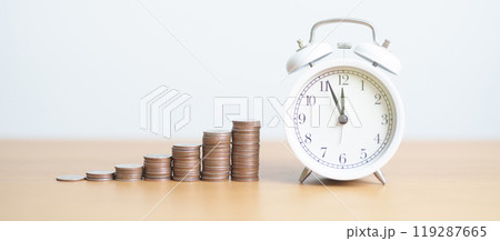 Money Saving for Future Plan, Retirement fund, Pension, Investment, Wealth Business and Financial concepts. coins money stack with clock on table 119287665