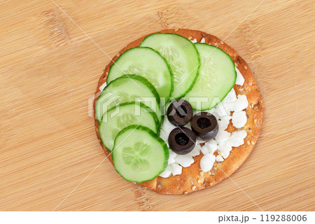 Crispy Cracker Sandwich with Fresh Cucumber, Cottage Cheese and Olives 119288006