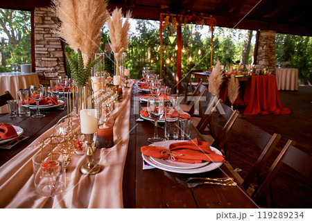 Table setting with orange napkins and glasses. Classic. Warm shades. Table setting with orange napkins and glasses. Classic. Warm shades. 119289234