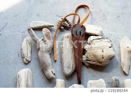 Jew's harp in a brown genuine leather case on a gray background. Sound therapy. Jew's harp in a brown genuine leather case on a gray background. Sound therapy. 119289284
