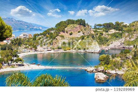 Beautiful Isola Bella, small island near Taormina, Sicily, Italy. Narrow path connects island to mainland Taormina beach surrounded by azure waters of Ionian Sea. 119289969