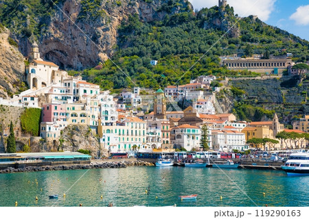 Beautiful Amalfi on hills leading down to coast, comfortable beaches and azure sea in Campania, Italy. Beautiful Amalfi on hills leading down to coast, comfortable beaches and azure sea in Campania, Italy. 119290163