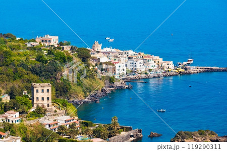 Ischia Ponte bordering waters of Bay of Cartaromana and Guevara Tower on Ischia Island, Italy. 119290311