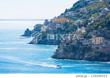 Amalfi coast with coloured terrace houses on hills leading down to sea located between Amalfi and Atrani in Campania, Italy. Amalfi coast with coloured terrace houses on hills leading down to sea located between Amalfi and Atrani in Campania, Italy. 119290333