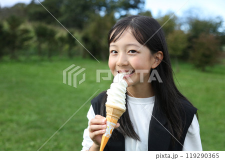 ソフトクリームを食べる女の子 119290365