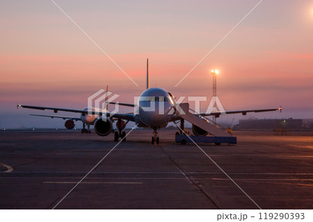 Passenger airplanes and twilight on the airport apron Passenger airplanes and twilight on the airport apron 119290393