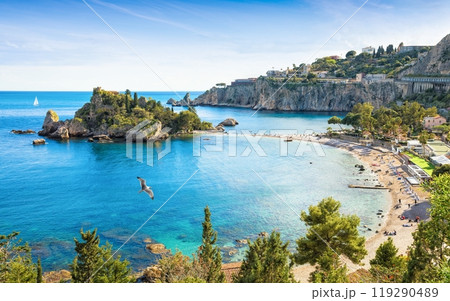 Beautiful Isola Bella, small island near Taormina, Sicily, Italy. Narrow path connects island to mainland Taormina beach surrounded by azure waters of Ionian Sea. 119290489