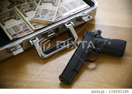 銃とアタッシュケースに入れられた札束 119291184
