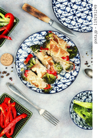 Meat rolls with broccoli and pepper on a plate. 119291249