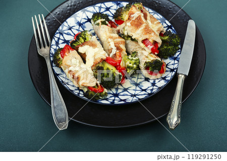 Meat rolls with broccoli and pepper on a plate. Meat rolls with broccoli and pepper on a plate. 119291250