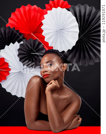Woman, portrait and beauty with origami fans in studio isolated on a dark background. Face, makeup cosmetics and skincare of black female model with traditional, culture and paper art for geisha Woman, portrait and beauty with origami fans in studio isolated on a dark background. Face, makeup cosmetics and skincare of black female model with traditional, culture and paper art for geisha 119291871