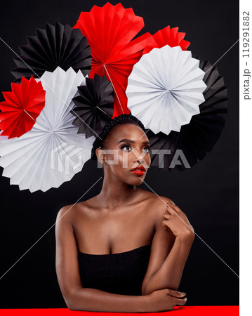 African, female person and origami on hair in dark, studio and background for fashion with style, art and decor. Woman, makeup and glamour for creativity, beauty or design with pride or confidence 119291882