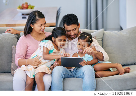 Games, parents and kids on sofa with tablet, internet and relax together in living room. Mom, dad and girl children on couch with digital app for streaming, playing and online connectivity in home Games, parents and kids on sofa with tablet, internet and relax together in living room. Mom, dad and girl children on couch with digital app for streaming, playing and online connectivity in home 119291967