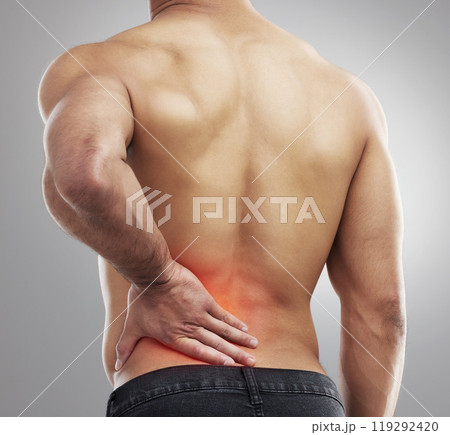 Studio, man and back pain with injury, accident and muscle tension as medical crisis. Backache, red glow and joint or bone strain with inflammation, fibromyalgia and emergency by gray background Studio, man and back pain with injury, accident and muscle tension as medical crisis. Backache, red glow and joint or bone strain with inflammation, fibromyalgia and emergency by gray background 119292420