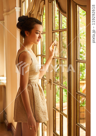 Asian woman, window and portrait of elegant fashion for gala, style and classy outfit or formal clothes. Wealth, aesthetic and lady with confidence, pride and luxury in vintage manor, home or mansion Asian woman, window and portrait of elegant fashion for gala, style and classy outfit or formal clothes. Wealth, aesthetic and lady with confidence, pride and luxury in vintage manor, home or mansion 119292618