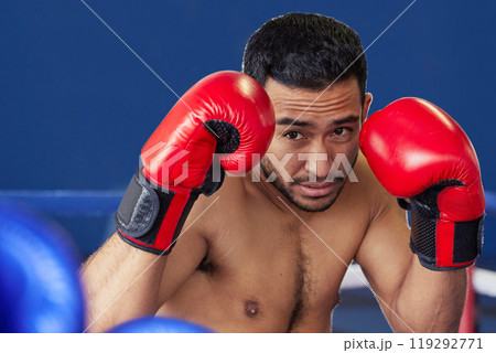 Man, athlete and fighting with gloves in ring for training, workout and practice for boxing competition. Boxer, pro champion and serious with sport for self defense, topless and healthy body in gym 119292771
