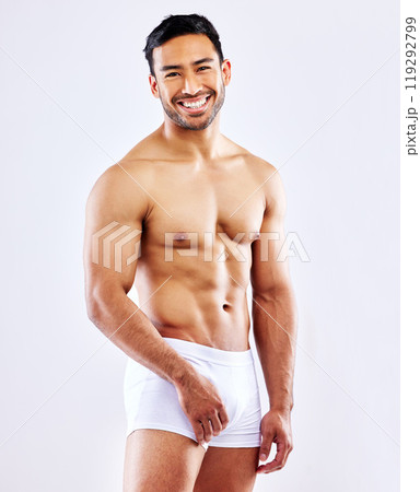 Fitness, man and happy in underwear on studio, white background or bodybuilder portrait in mockup. Healthy, athlete and model with abs, arms or muscle from exercise and progress from workout at gym Fitness, man and happy in underwear on studio, white background or bodybuilder portrait in mockup. Healthy, athlete and model with abs, arms or muscle from exercise and progress from workout at gym 119292799