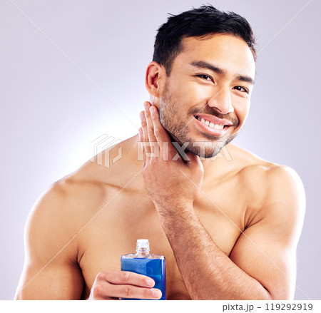 Model, smile and aftershave for face, grooming and beard for beauty and aesthetic wellness for healthy skin on studio background. Happy, guy and man for facial hair or dermatology, body and cosmetics Model, smile and aftershave for face, grooming and beard for beauty and aesthetic wellness for healthy skin on studio background. Happy, guy and man for facial hair or dermatology, body and cosmetics 119292919