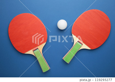 Ping pong rackets and ball on blue background 119293277