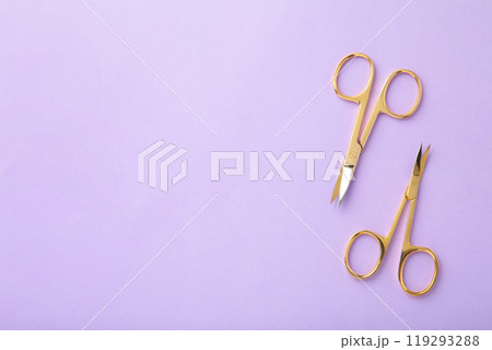 Scissors for manicure woman nails on purple background with copy space 119293288