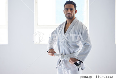 Man, portrait or belt for martial arts sport in fitness center for self defense, fighting and discipline. Pro athlete, face and serious with uniform for training, practice or wellness for competition 119293338