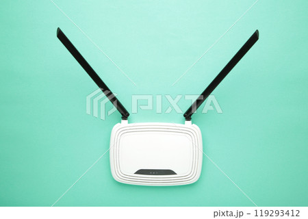 White wi-fi router with black antennas on mint background with copy space. Minimalism 119293412