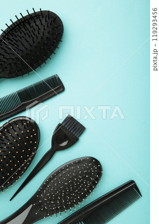 Hair tools, beauty and hairdressing concept - different brushes or combs on blue background. Vertical photo with copy space 119293456